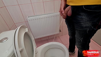 Uncircumcised cock pees on the station toilet