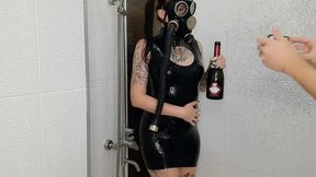 Backstage from the Halloween shoot. Mistress in a gas mask and latex is doused with wine