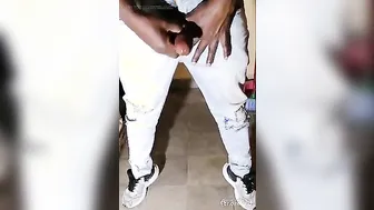 Twink in tight denim jeans strokes his big uncut cock to a cumshot
