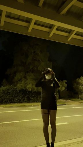 sissy femboy in short dress waiting for bus at night