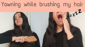 Yawning while brushing my long hair
