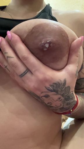 Lactating babe shows off her tits while feeding baby