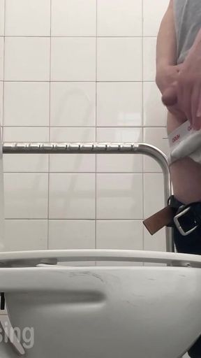 In the Hospital Toilets, a Guy Pisses Into a Cup for a Urine Sample, Then Gets Horny, Jerks-off and Cums