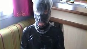 Nasty slut in latex outfit puts a plastic bag over her head