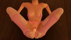 pink is using her dildo with her feet.