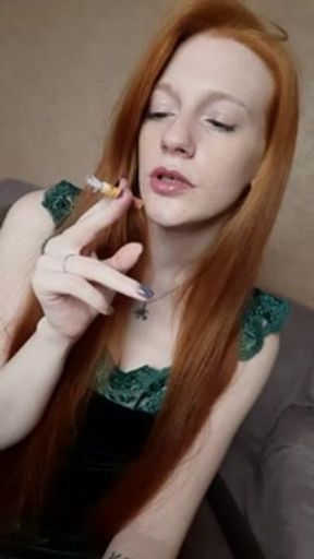 A red-haired girl with long hair smokes a cigarette with a brown