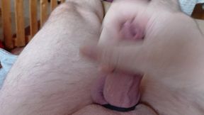 lies and jerks his cock on the couch until he orgasms