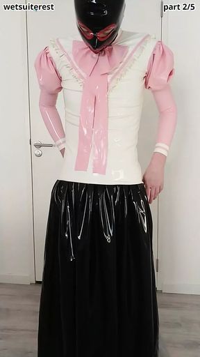Putting on pink frilly latex blouse over long rubber skirt, maid stockings, transparent panties, layers