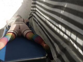 Caged sissy plays with her sextoy on public balcony