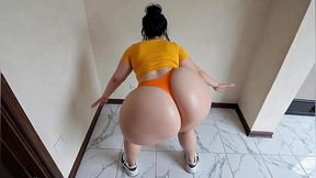 big-bootied woman in orange leggings moving