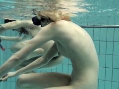 Girls swimming underwater and enjoying eachother