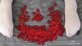 Nylon foot play with red plastic hearts in Valentine's Day