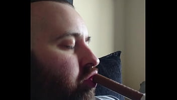 Hot bearded guy gagging on chocolate bar.