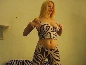 Big titted blonde is posing for the camera