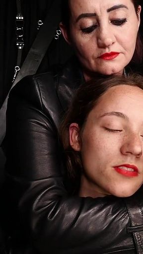 Lady Amber Encases Slave Mila Layers of Leather