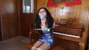 Khrystal the famous pianist, wearing a cosmic dress, tied and gagged by a jealous pianist who wants to ruin her career!