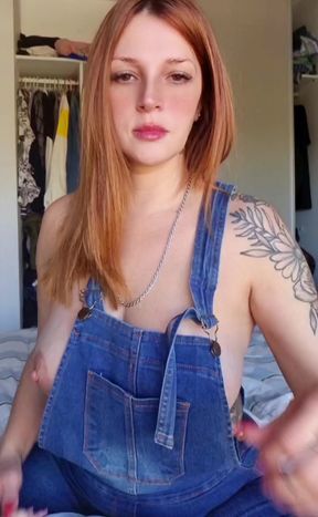 Sexy blonde woman in denim overalls