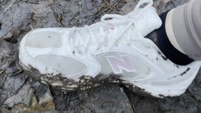 New Balance 530 walking in muddy forest