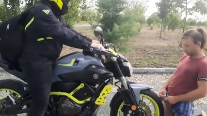 a client gives a massage with his motorcycle until he ejaculates, sperm on the front tire of the motorcycle filmed in Agigea Park on a beautiful Sunday day