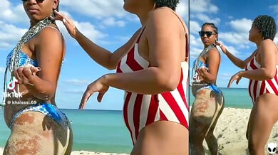 Two dark-skinned brunettes grind clits in a hotel after a beach day with a tattooed man joining