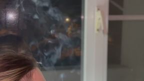 YULIANA SMOKE IN FRONT OF THE GLASS