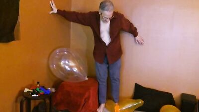 Amateur grandpa is playing with a balloon in his solo performance