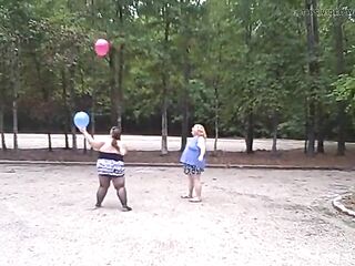 BBW gals play volley ball with balloons