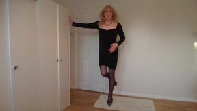 Blonde in a little black dress, stockings and stripper heels
