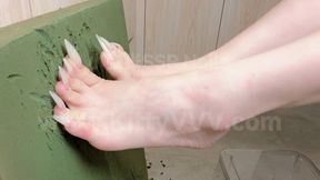 Clawing away at a board with my long natural toenails