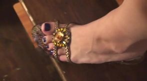 Dangling her feet on the stairs