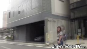 Teenage Asian redhead filmed while peeing on the street
