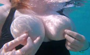 Chubby girlfriend enjoys underwater fun with her boyfriend, giving a footjob and flaunting her big boobs.