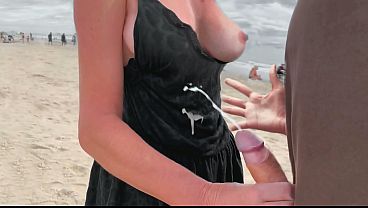 Mature MILF jerks off stranger for a bet on public beach