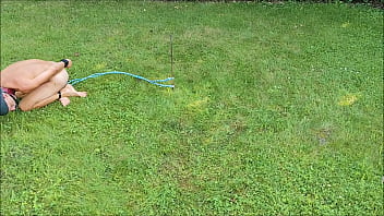 naked pathetic slave outdoor in penis cage tied up at his testicles, jumps around for entertaining the guests, cmnm