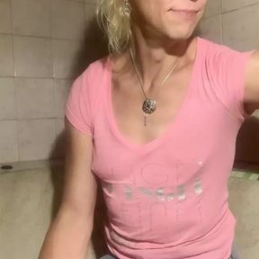 Soaking wet in bathroom in pink t-shirt, denim skirt and socks