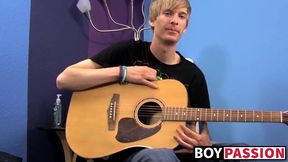 Young man plays guitar before dick stroking and cumming