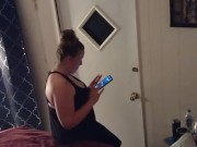 Pretty girl smoking in her night dress while watching tv