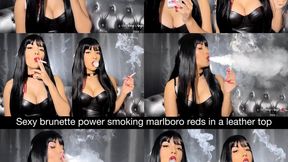 Sexy brunette powersmoking Marlboro Reds in a leather top