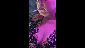 Sitting on a stool in a flowered blouse while I smoke a 120
