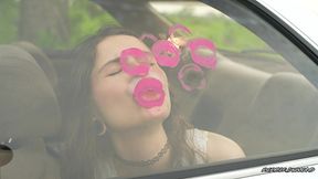 messy pink lipgloss marks on the car window