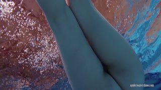 Redheaded Katrin stripping underwater
