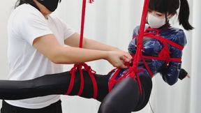 Female investigator suspended by ropes, legs spread in an M-shape, stimulated to orgasm
