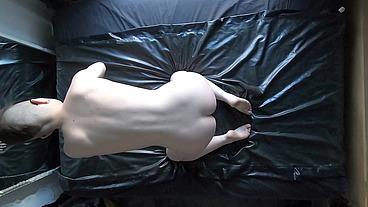 Your favorite naked slave cleaning a big sheet of latex with a big plug in their butt