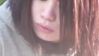 Young Japanese babe filmed toying pussy at a bus stop