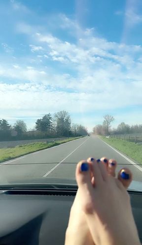Hot blonde milf plays with her toes while driving a car