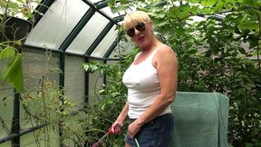 rae hart outside watering her garden plants