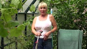 rae hart outside watering her garden plants