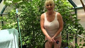 rae hart outside watering her garden plants