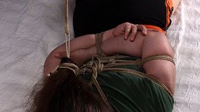 Marlene: barefoot girl, wearing green t-shirt and sport shorts, hogtied with her foot tightly tied to her hair tie, wiggles on the bed, unable to turn to her side (HD MP4)