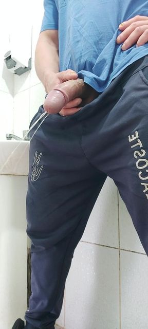 A Well-endowed Brazilian Man Urinating and Showing His Thick Penis to His Female Friends.